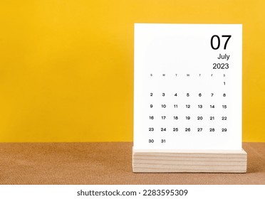 July 2023 Monthly calendar for 2023 year on yellow table. - Shutterstock ID 2283595309