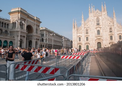 July 24, 2021, Milan, Italy - People protesting against the Green Pass act of the government. Facade of the Duomo (Milan Cathedral) in the background. Crush barriers in the foreground.