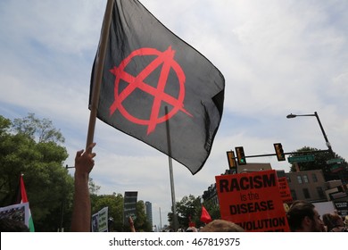 July 26th, 2016 Philadelphia, PA: Democratic National Convention - An Anarchist flag waves over a crowd of demonstrators 