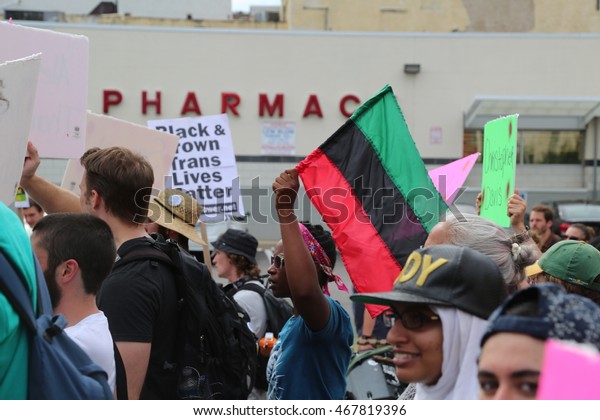 July 26th, 2016 Philadelphia, PA: Democratic National Convention - A Man walks with the Black Lives Matter movement carrying a Pan-African Flag