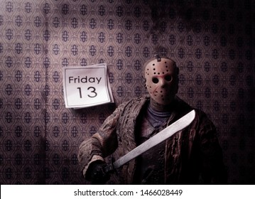 JULY 30 2019: Friday the 13th slasher Jason Voorhees with wall calendar showing the date Friday 13 - NECA Ultimate Jason action figure