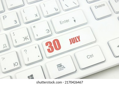 July 30th. Day 30 Of Month, Calendar Date. Cropped View Of Modern White Computer Keyboard With Calendar Date. Concept Workspace, Freelance, Deadline.  Summer Month, Day Of The Year Concept