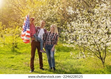 July 4th: American Family Behind US Flag