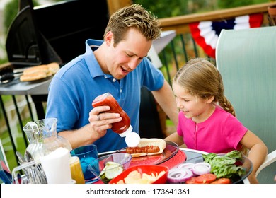 July 4th: Dad Helps Girl With Ketchup