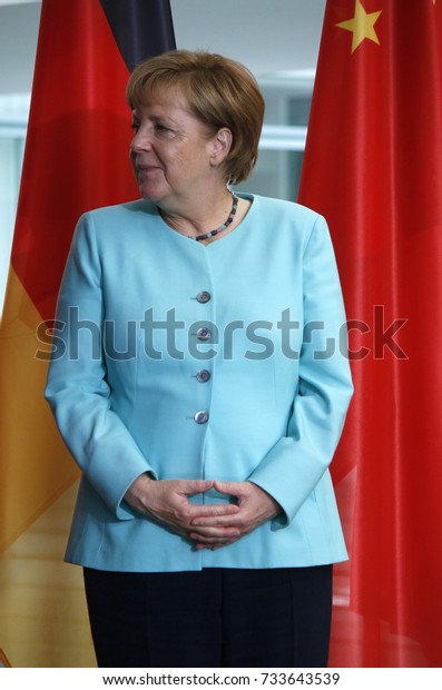 angela merkel hands glue