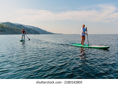 July 5, 2022. Dalaman, Turkey. Older Couple On SUP Board On Blue Sea. Active Lifestyle For Aged Man And Woman