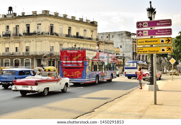 July 7, 2019.\
Havana, Cuba. an old classic American car for tourism, goes through\
an avenue in the historical and touristic center of the old Havana,\
in search of tourists