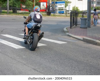 July 7, 2021, Khabarovsk, Russia. A Motorcyclist On A Sports Motorcycle Is Driving Along A City Road And Is Going To Turn Right.