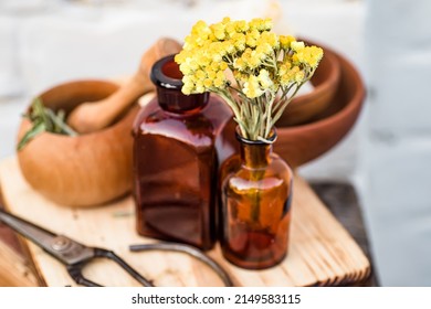 july arenarium, helichrysum arenarium, dwarf everlast, immortelle, curry plant, italian strawflower apothecary bottles with tincture and essential oils for beauty salons and alternative medicine