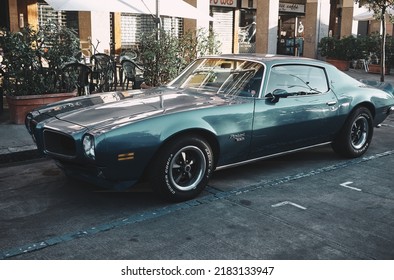 JULY ITALY - Milan 2022 - American Retro Muscle Car Parked In The Old Street Of The European City