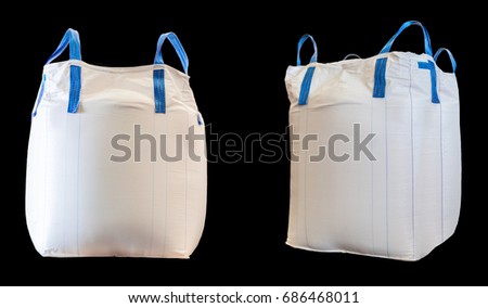 Jumbo bag of white sugar isolated on black background.