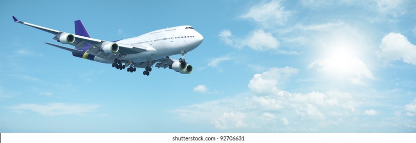 Jumbo Jet Aircraft Is Maneuvering In A Sunny Sky. Panoramic Composition.