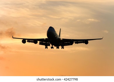 Jumbo Jet Approaching Landing At Sunset