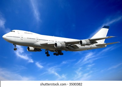 Jumbo Jet And Blue And Cloudy Sky.