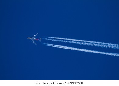 A Jumbo Jet Flying High With Contrails