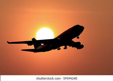 Jumbo Jet Landing In A Sunset