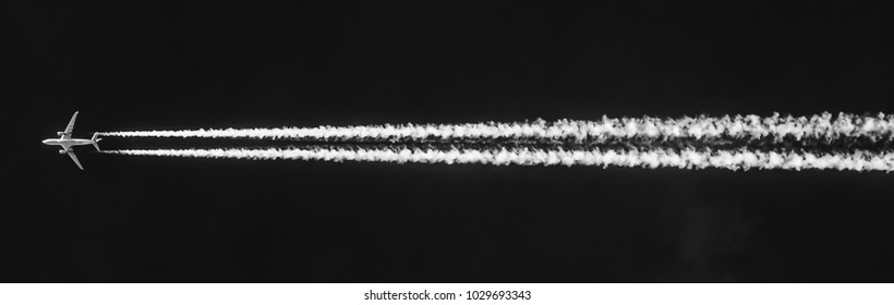 Jumbo jet leaving trails high up in black sky-Outdoor and transportation photography 2018