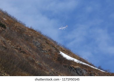 A Jumbo Jet Viewed On Approach To Anchorage From The Kenai Peninsula. Heat Refraction From The Nearby Mountainside Distorts The Image Of The Plane.
