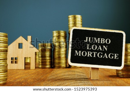 Jumbo Loan mortgage inscription and stacks of coins.