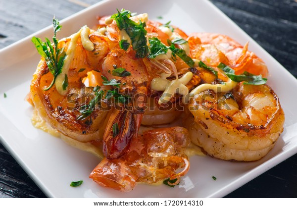 Jumbo shrimp, pan seared in garlic, butter,\
shallots and white wine. Classic traditional American or French\
cuisine. Served with steamed organic vegetables, broccoli carrots\
cauliflower and lemons.