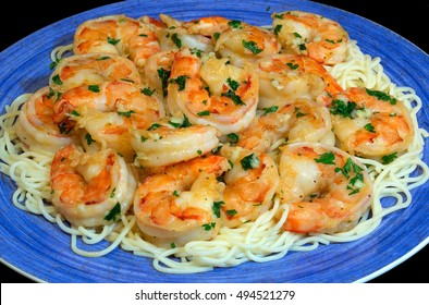 Jumbo Shrimp Scampi Sitting On A Bed Of Pasta