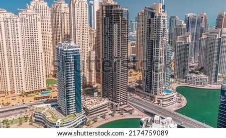Jumeirah Beach Residence and original architecture yellow towers in Dubai aerial timelapse. Residential area on a seaside near Dubai marina with construction site