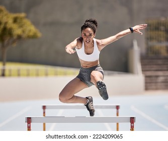 Jump, athlete and hurdle black woman in sports race, competition or training at stadium with energy, power and body challenge. Fast, speed and runner at an arena course or field for workout exercise - Powered by Shutterstock