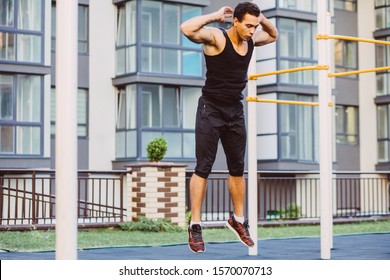 Jump Up Burpee. Sport Exercises. Stage And Release Of Squat. Exercises With Free Weight. Mixed Race Black Man Workout Jump Exercise On Sport Ground Outdoor With Urban Cityscape On Background.