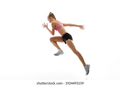 In jump. Caucasian professional female athlete, runner training isolated on white studio background. Muscular, sportive woman. Concept of action, motion, youth, healthy lifestyle. Copyspace for ad. - Powered by Shutterstock