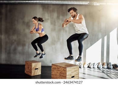 Jump, fitness and couple in workout with box, power and training challenge at gym together. Man, woman and personal trainer with balance, muscle development and healthy body exercise at sports club - Powered by Shutterstock