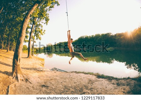 Image, Stock Photo Swimming fun at quarry pond, young adults swing into the water