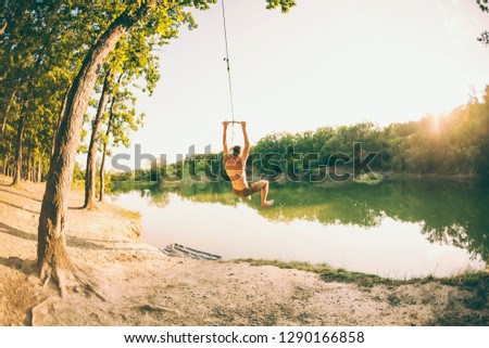 Similar – Image, Stock Photo Swimming fun at quarry pond, young adults swing into the water