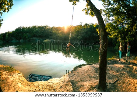 Similar – Image, Stock Photo Swimming fun at quarry pond, young adults swing into the water