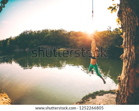 Similar – Image, Stock Photo Swimming fun at quarry pond, young adults swing into the water