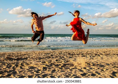 Jump Of Joy On The Sunset Beach