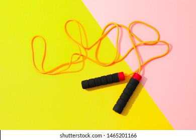 Jump rope on two tone background, space for text
