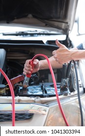 A Jump Start, Act Of Using A Charged Battery With A New One Or Another Car With A Big Pair Of Battery Jumper Cable, Safely Jump Start A Dead Battery Concept.