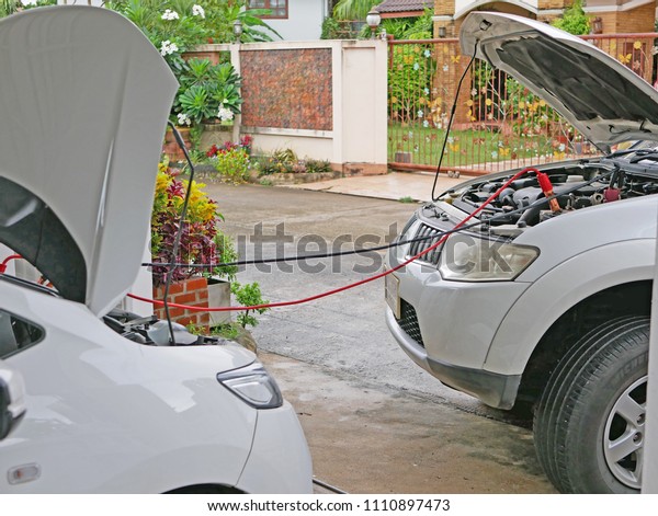 Jump starting a\
car battery using two cables to make the engine able to get started\
temporarily - battery\
problem
