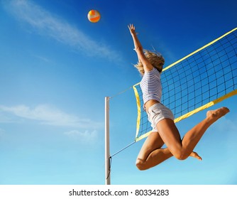 Jump of young girl, playing volleyball on beach. - Powered by Shutterstock