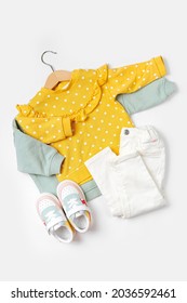 Jumpers On Hanger And Pants With Sneakers. Set Of Baby Clothes And Accessories For Spring, Autumn Or Summer On  White Background. Fashion Kids Outfit. Flat Lay, Top View