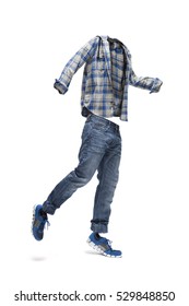 Jumping empty clothes. Checked shirt, worn jeans and blue trainers.