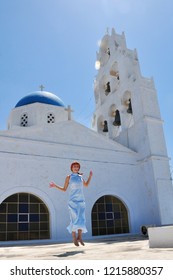 Jumping Girl Near The Church On Greek Island