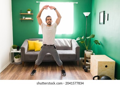 Jumping Jack Exercises During HIIT Training. Fitness Young Man Doing His Cardio Workout 