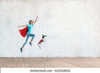 Jumping little child with a dog indoors