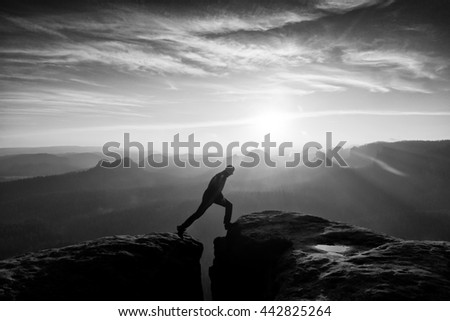 Similar – photographer in mountain at sunset