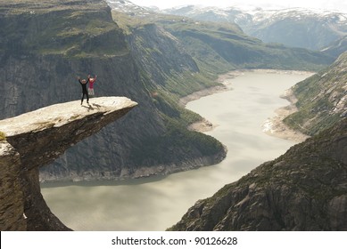 Jumping on the rock high above the fjord