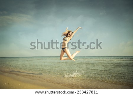 Similar – Young, slim woman on the beach of the Baltic Sea in summer wind