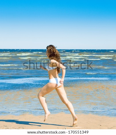 Similar – Young, slim woman on the beach of the Baltic Sea in summer wind