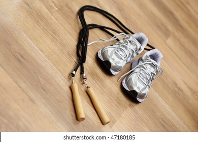 Jumping rope and trainers on a gym floor - Powered by Shutterstock