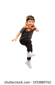 Jumping, running. Happy, smiley little caucasian boy isolated on white studio background with copyspace for ad. Looks happy, cheerful. Childhood, education, human emotions, facial expression concept.